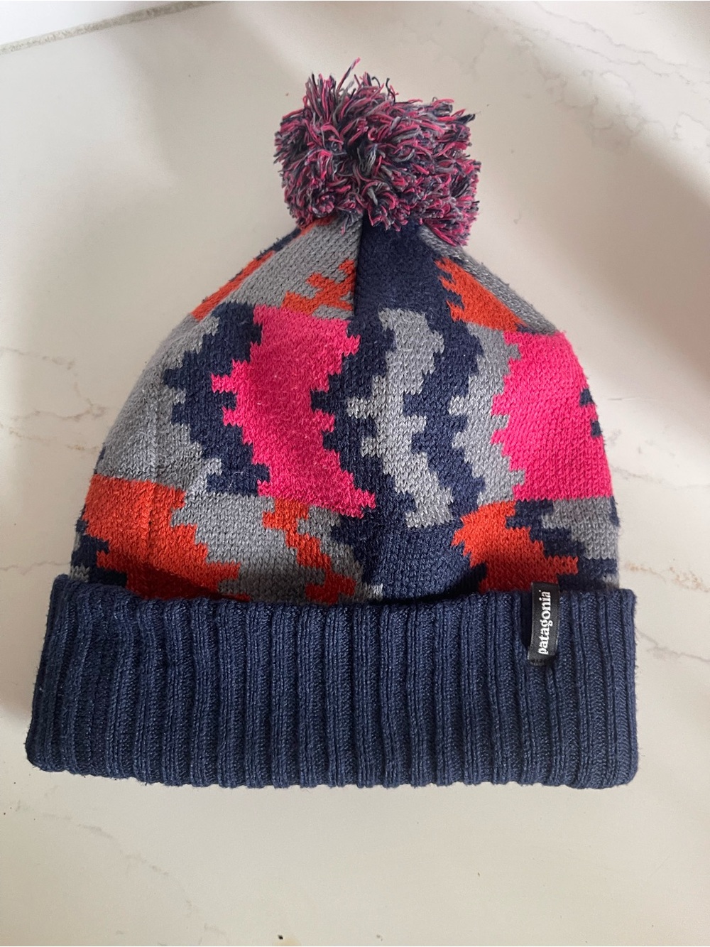 Patagonia Knit Pom Beanie in Navy, Pink & Orange
